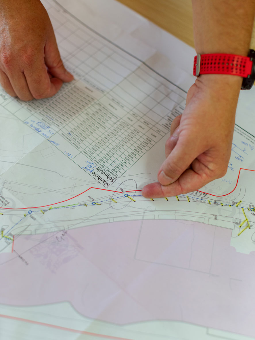 A civil engineer observing the drawing of a project.