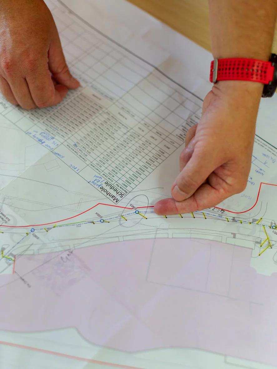 A civil engineer observing the drawing of a project.