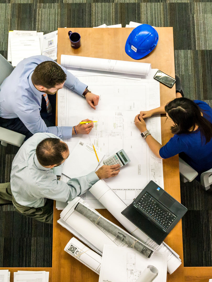 Engineers and project managers discussing the scope and time-frame of a construction project.